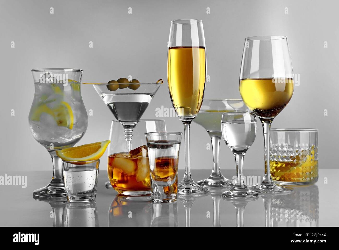 Glasses of wine and spirits on light background Stock Photo Alamy