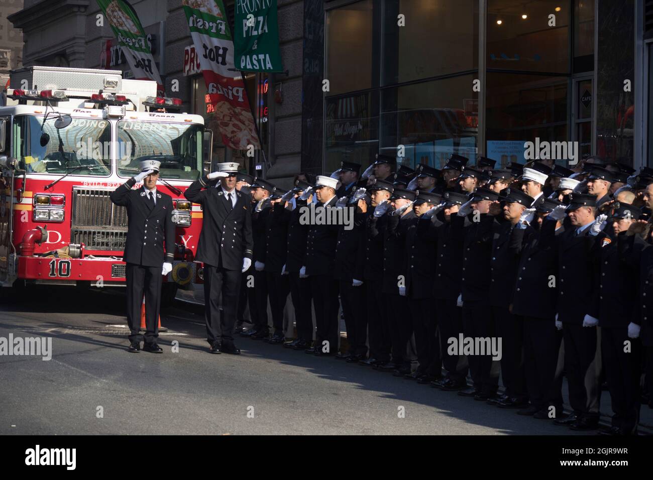 New York, New York. 11th Sep, 2021. Members of FDNY Ten House, Engine Company 10 and Ladder Company 10, stand at attention in remembrance of the 343 firefighters who gave their lives on 9/11/01, on the 20th anniversary of the September 11, 2001 terrorist attack on the World Trade Center and the Pentagon in New York, New York, on Saturday, September 11, 2021. Credit: Allan Tannenbaum for CNP/dpa/Alamy Live News Stock Photo