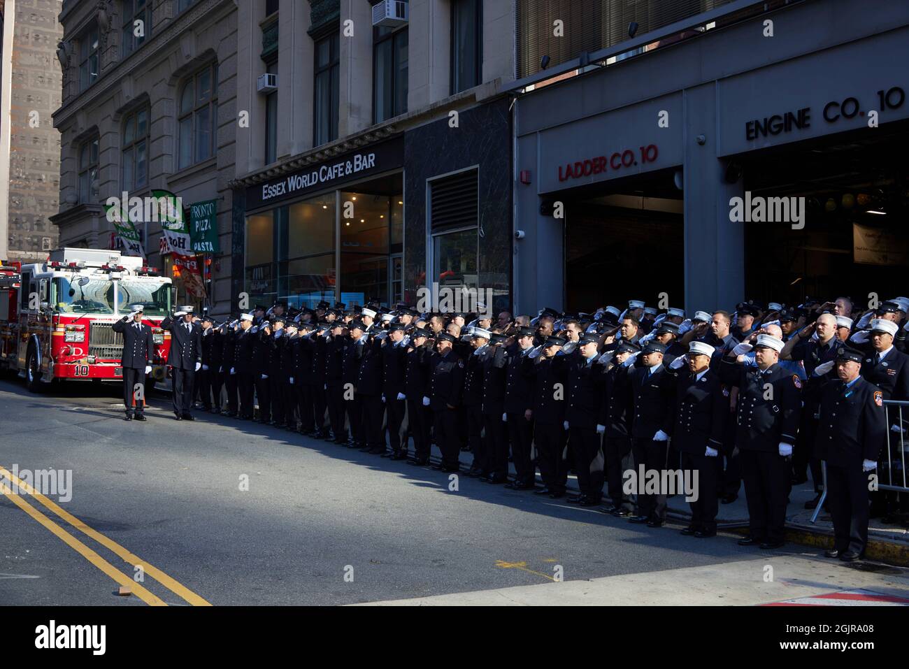 New York, New York. 11th Sep, 2021. Members of FDNY Ten House, Engine Company 10 and Ladder Company 10, stand at attention in remembrance of the 343 firefighters who gave their lives on 9/11/01, on the 20th anniversary of the September 11, 2001 terrorist attack on the World Trade Center and the Pentagon in New York, New York, on Saturday, September 11, 2021. Credit: Allan Tannenbaum for CNP/dpa/Alamy Live News Stock Photo