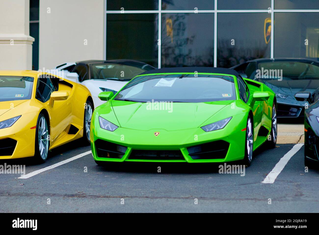 Sterling, Virginia, USA - December 9, 2018: Green and yellow Lamborghini luxury sports cars for sale at the Lamborghini Sterling car dealership. Stock Photo