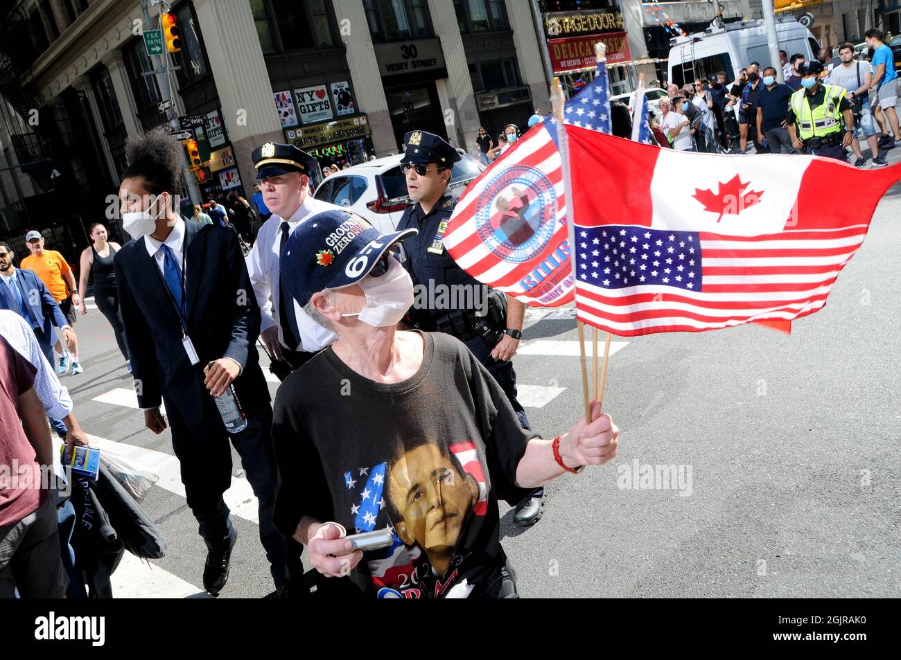 New York City, United States. 11th Sep, 2021. A person holds flags on the 20th Anniversary of the events of 9/11, in New York City. Credit: SOPA Images Limited/Alamy Live News Stock Photo