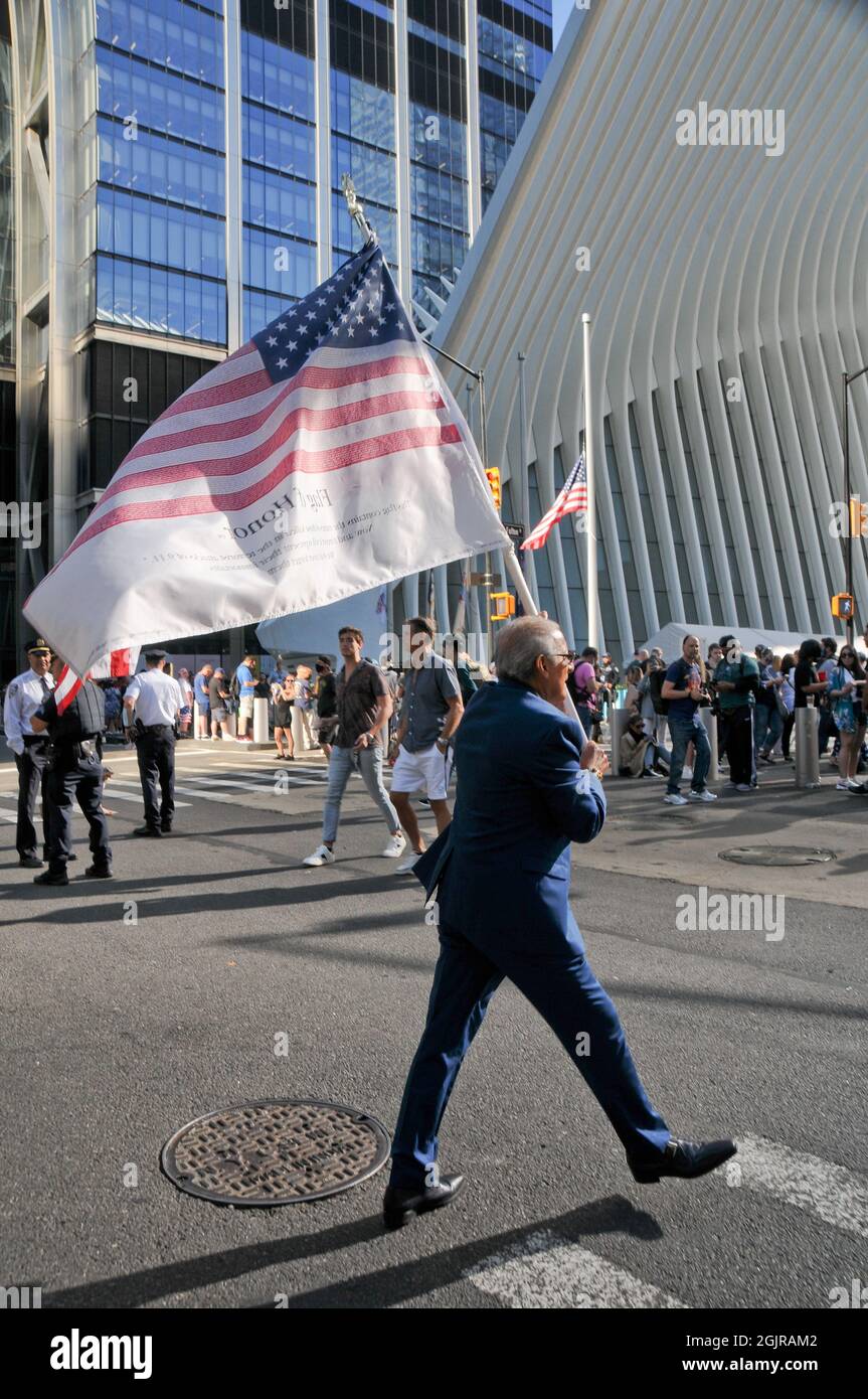 New York City, United States. 11th Sep, 2021. A man holds an American flag on the 20th Anniversary of the events of 9/11, in New York City. Credit: SOPA Images Limited/Alamy Live News Stock Photo