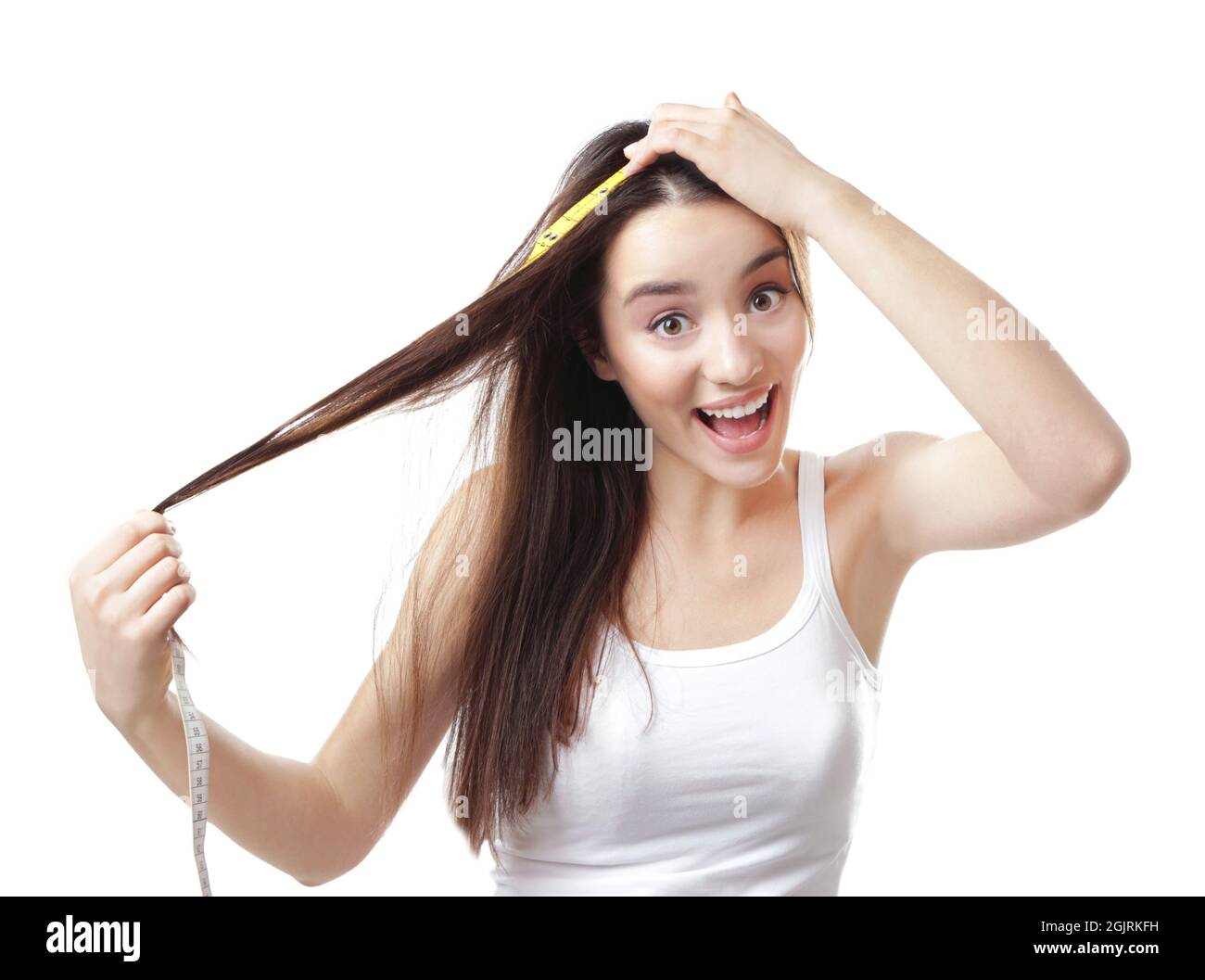 Young woman measuring hair length on white background Stock Photo Alamy