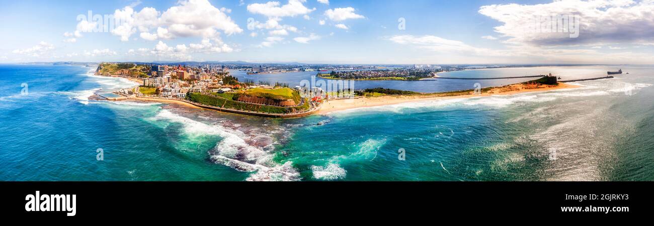 Entire Newcastle city CBD in wide aerial panorama from Pacific ocean facing Hunter Valley and city beaches. Stock Photo