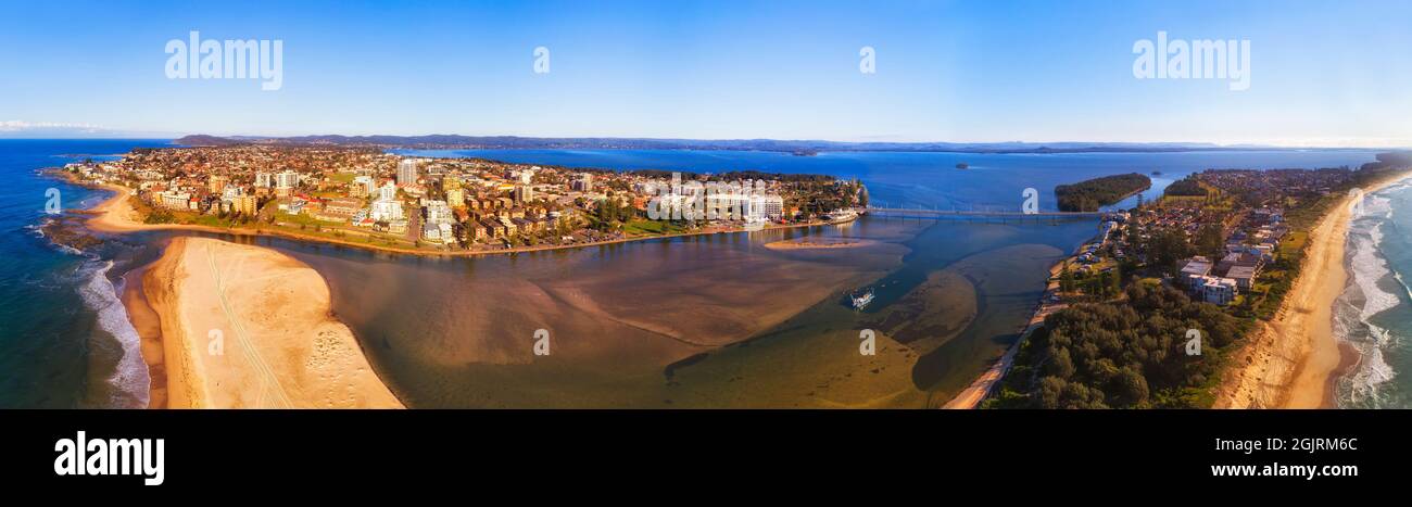 The entrance town on AUstralian Pacific coast of the Central coast at the entrance of Lake Tuggerah - wide aerial panorama. Stock Photo