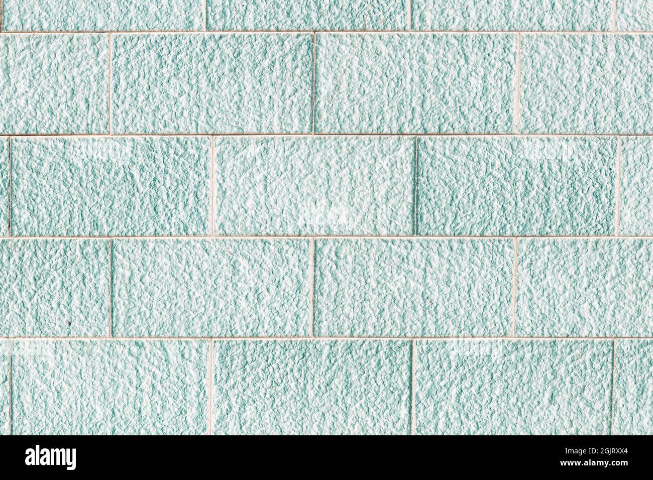 Background texture of rectangular turquoise ceramic tiles. Stock Photo