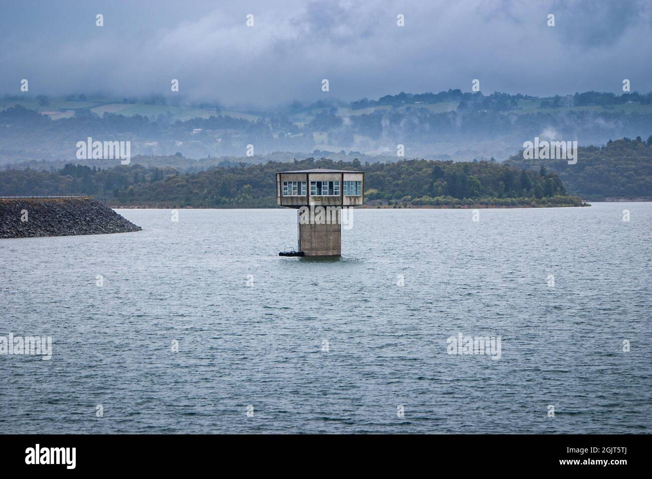 Control tower rising out of the water at Cardina Lake Reservoir Stock Photo