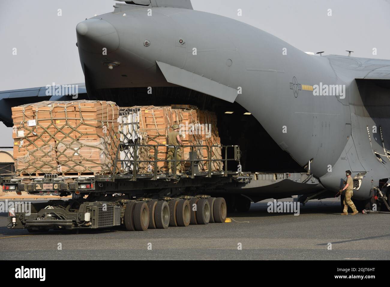 The 816th Expeditionary Airlift Squadron loads pallets of cots on to a