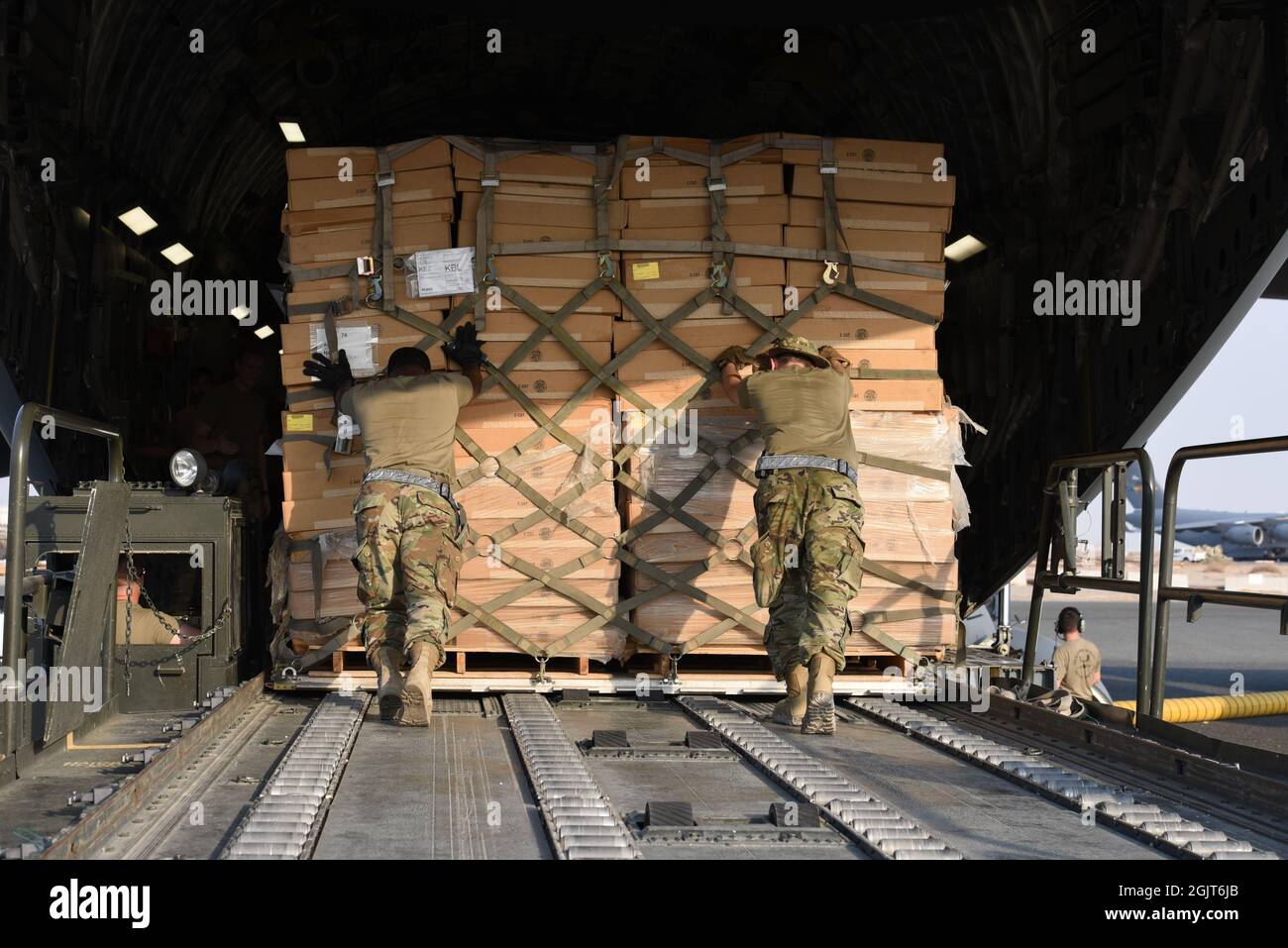 The 816th Expeditionary Airlift Squadron loads pallets of cots on to a