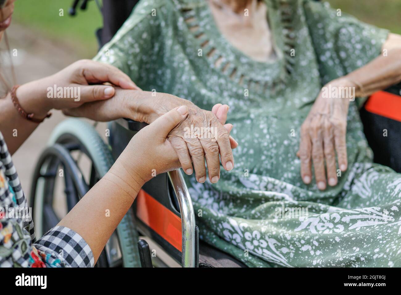 Elderly asian woman on wheelchair at home with daughter take care Stock Photo