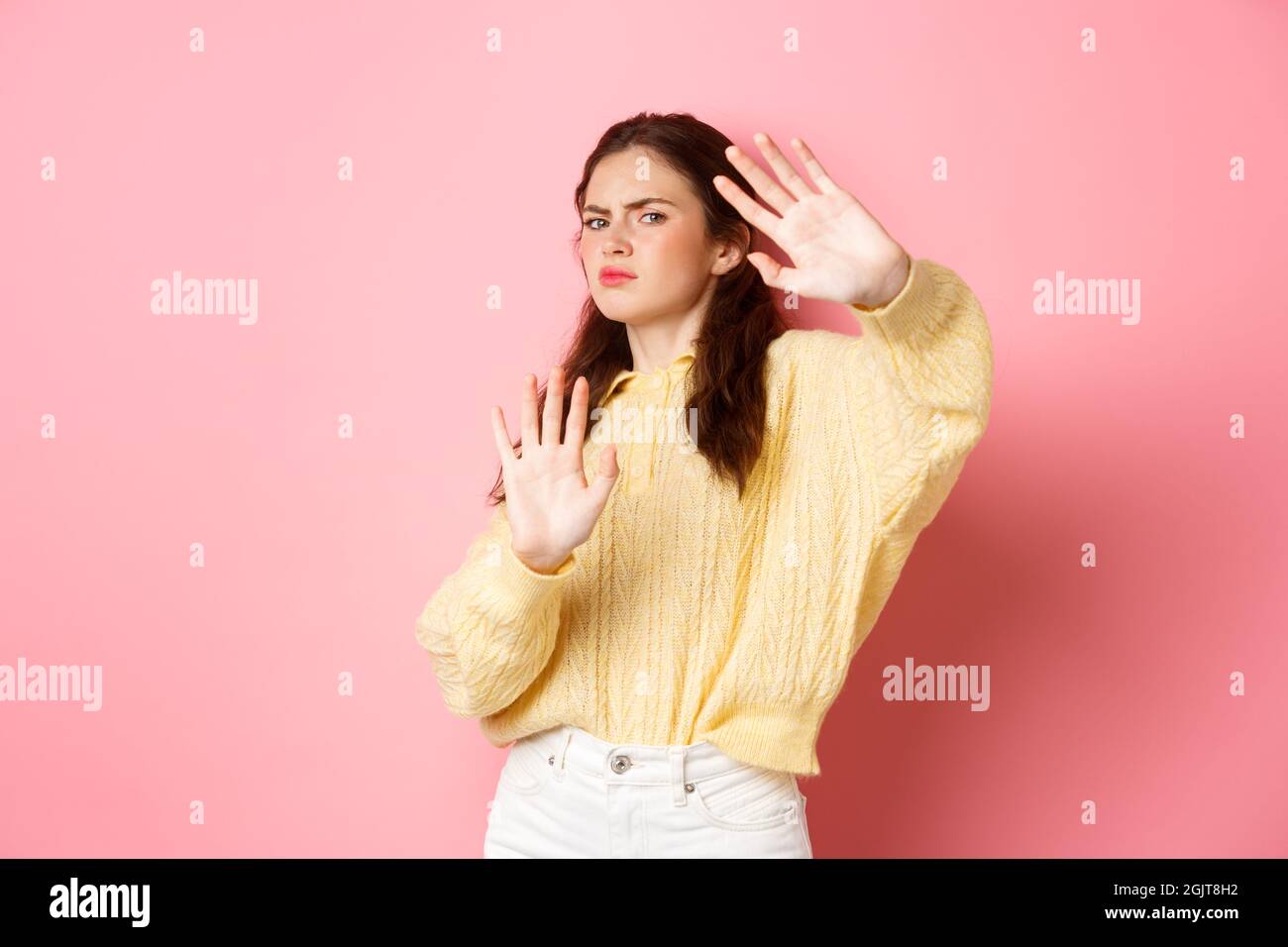 Please stop, enough. Displeased and reluctant young woman stay back ...