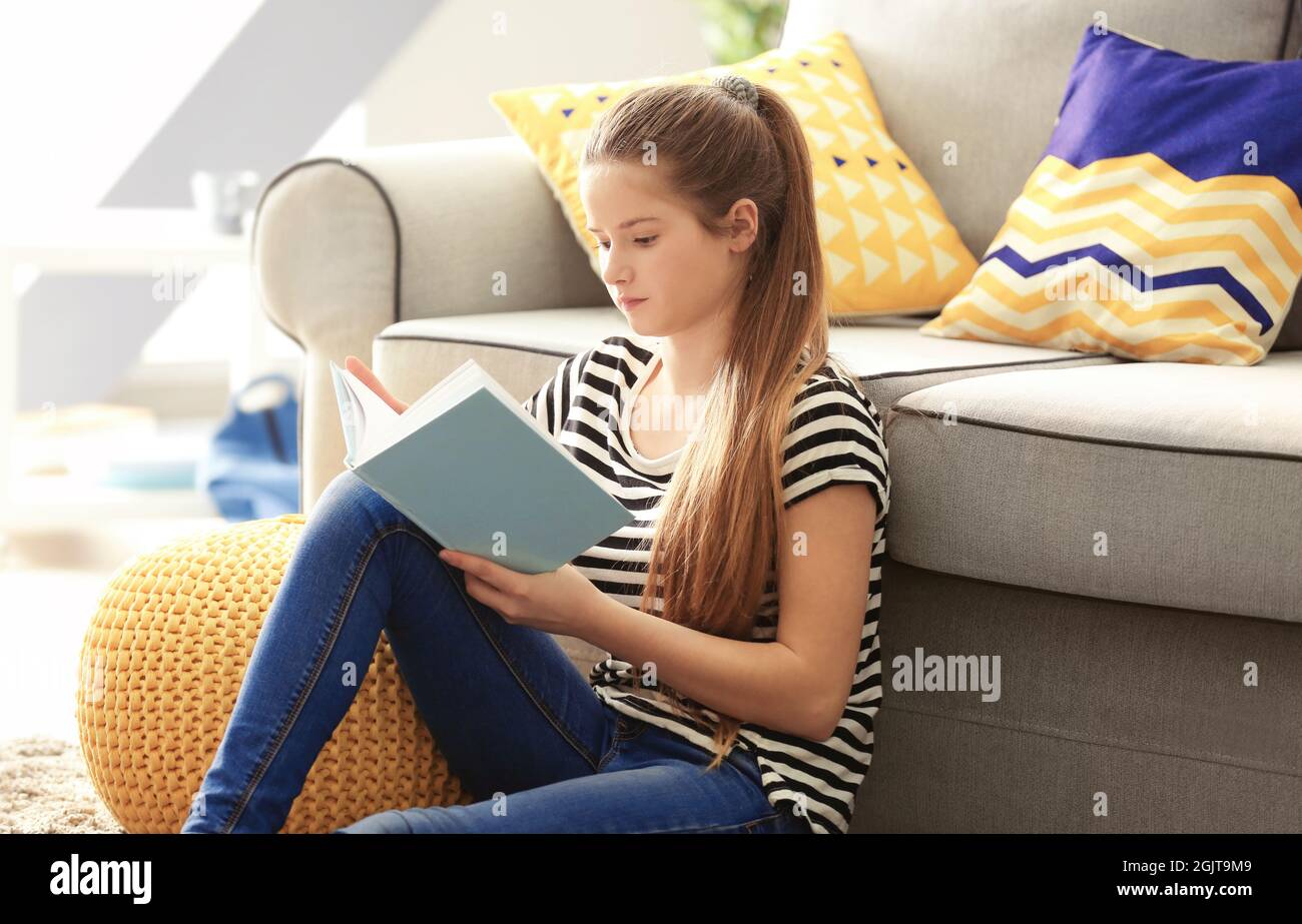 Pretty teenager girl sitting on floor at home Stock Photo - Alamy