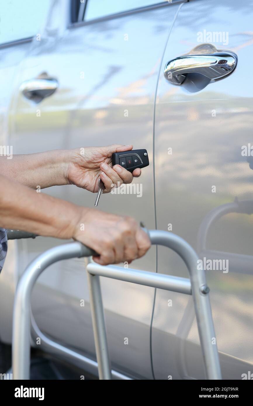 Elderly woman hand open the car on key car alarm systems Stock Photo