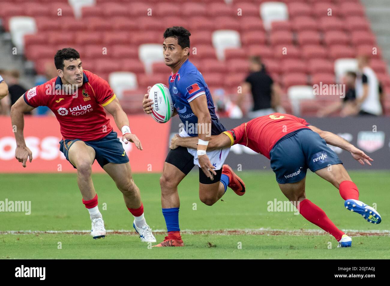 SINGAPORE-APRIL 13:Samoa 7s Team (blue) plays against Spain 7s team (red) during Day 1 of HSBC World Rugby Singapore Sevens on April 13, 2019 at National Stadium in Singapore Stock Photo