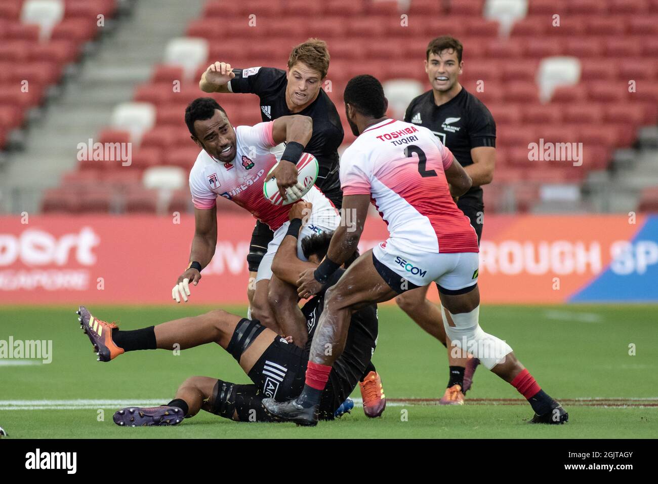 SINGAPORE-APRIL 13:Japan 7s Team (white/red) plays against New Zealand 7s team (black) during Day 1 of HSBC World Rugby Singapore Sevens on April 13, 2019 at National Stadium in Singapore Stock Photo