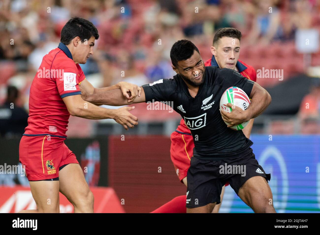 SINGAPORE-APRIL 13:New Zealand 7s Team (blalck) plays against Spain 7s team (red) during Day 1 of HSBC World Rugby Singapore Sevens on April 13, 2019 at National Stadium in Singapore Stock Photo