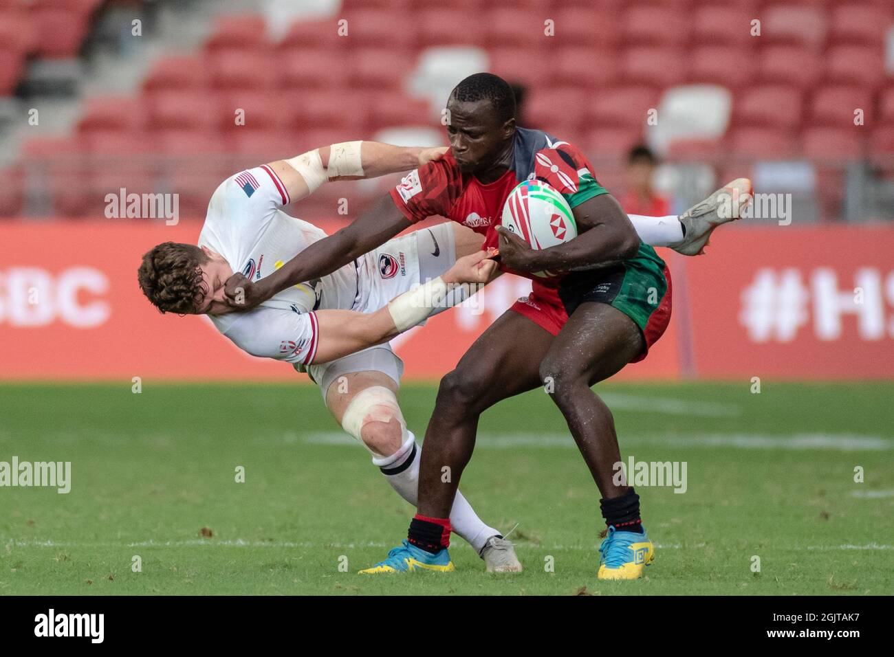SINGAPORE-APRIL 13:Kenya 7s Team (red) plays against USA 7s team (white) during Day 1 of HSBC World Rugby Singapore Sevens on April 13, 2019 at National Stadium in Singapore Stock Photo