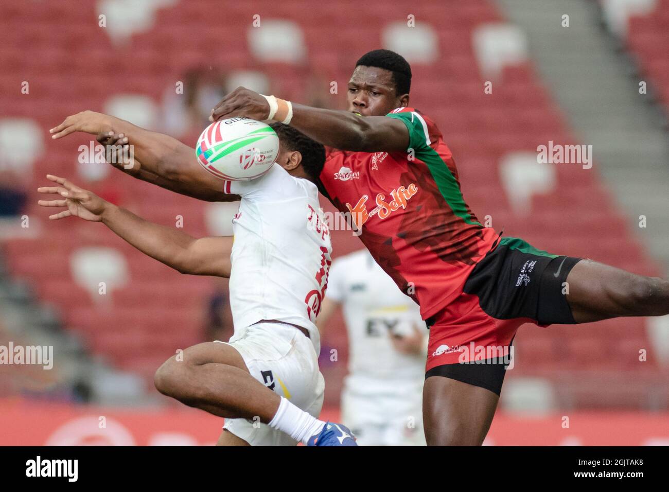 SINGAPORE-APRIL 13:Kenya 7s Team (red) plays against USA 7s team (white) during Day 1 of HSBC World Rugby Singapore Sevens on April 13, 2019 at National Stadium in Singapore Stock Photo