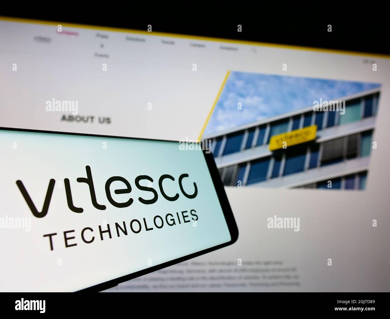 Cellphone with logo of German automotive supplier Vitesco Technologies on screen in front of business website. Focus on center of phone display. Stock Photo