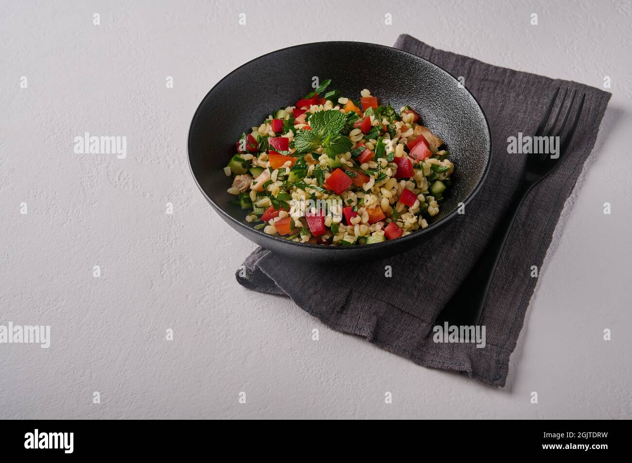 Eastern traditional salad tabbouleh made of bulgur or couscous, poultry