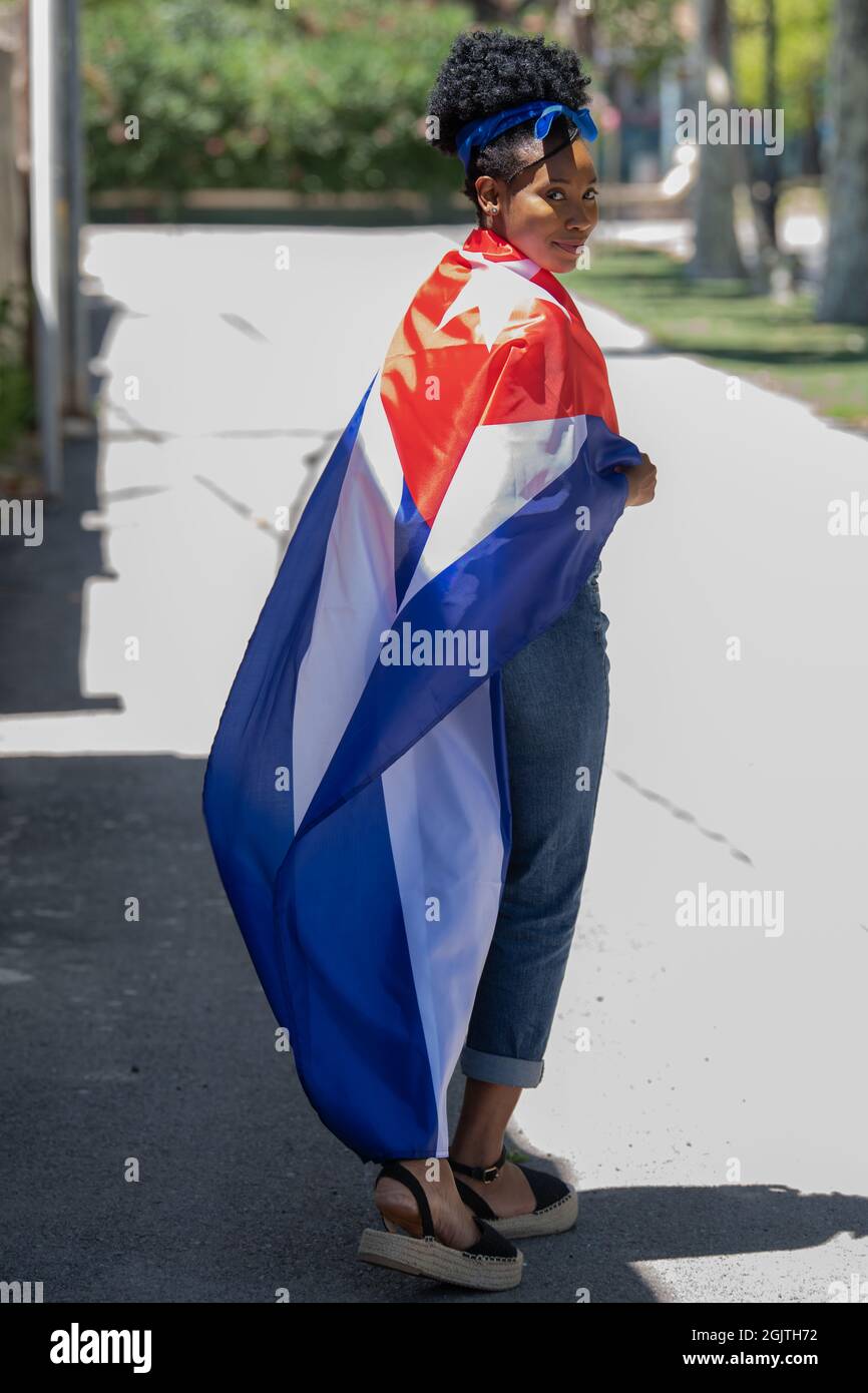 Close up of a latin woman wearing the cuban flag smiling at the camera Stock Photo