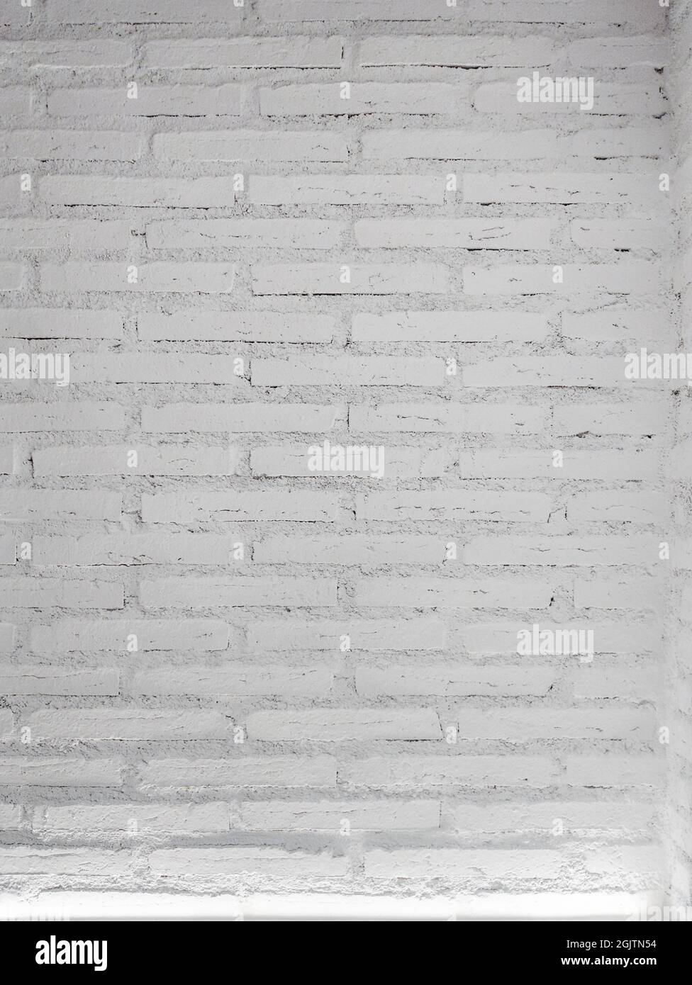 White brick wall background with a light. vertical size. Stock Photo