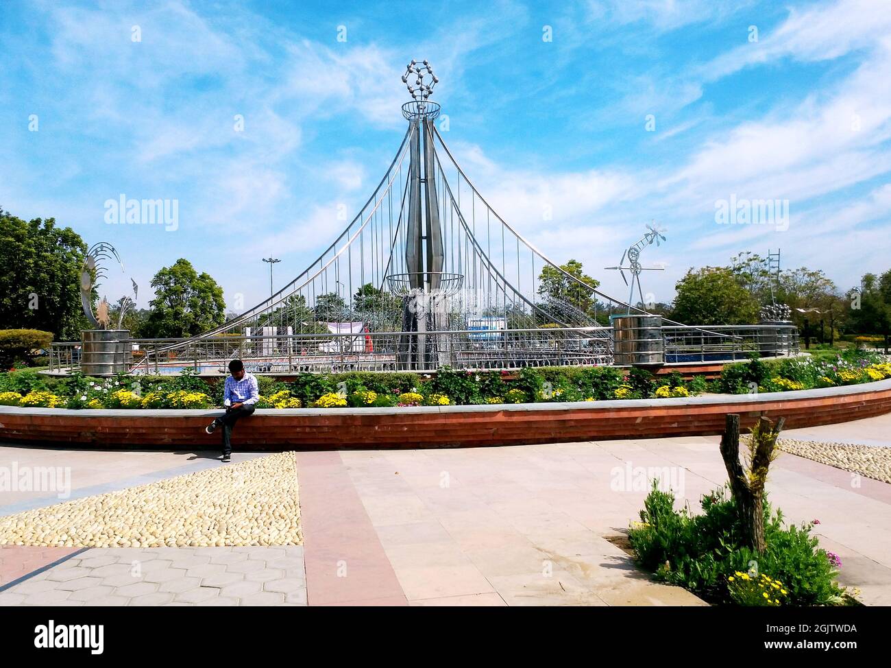 March, 2020 a boy sitting and using a mobile at pushpa gujral science