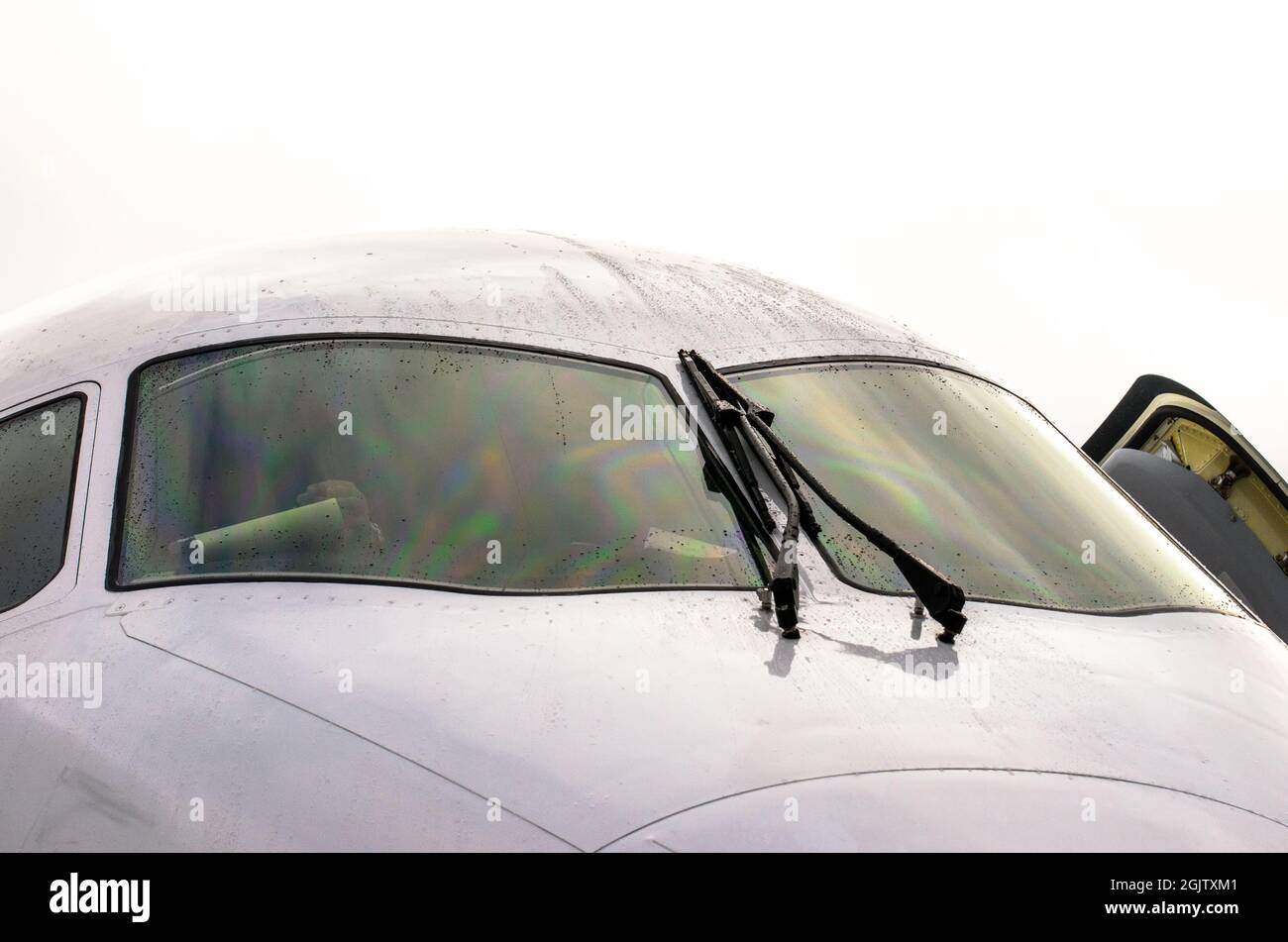 The pilot's cockpit aircraft with wipers on the windshield, rain drops