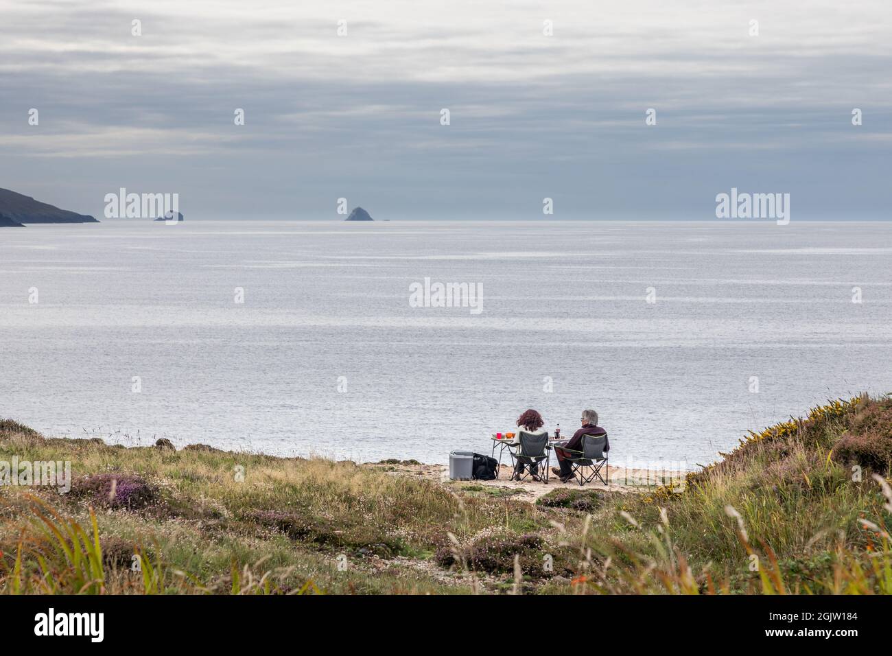 Allihies, Cork, Ireland. 11th September, 2021. Holidaymakers Martine Vandeveegaete and Andre Derval from Lessines in Belgium having an afternoon picnic with a view of Beara's Wild Atlantic Way at Dooneen, Allihies, West Cork, Ireland. - Picture; David Creedon / Alamy Live News Stock Photo