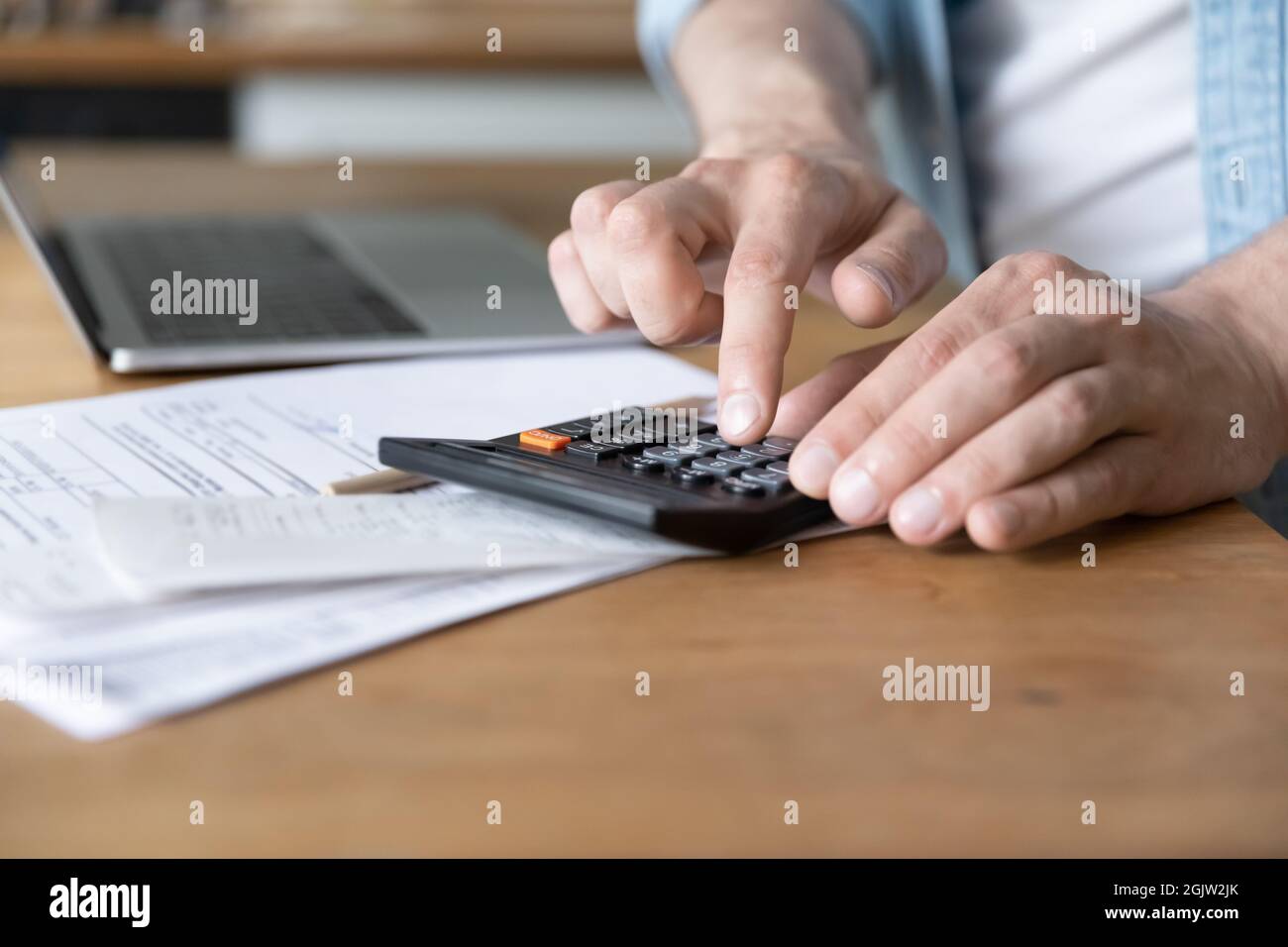 Man costs personal incomes and expenses using calculator close up Stock Photo