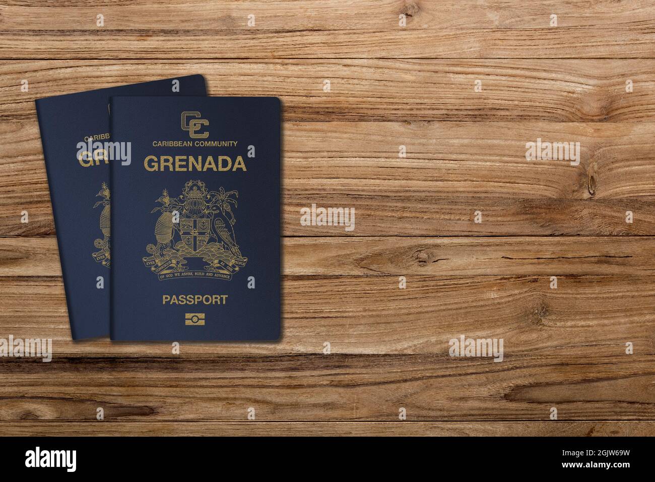 Grenada passport on a wooden background, for citizens of the state of Grenada Stock Photo