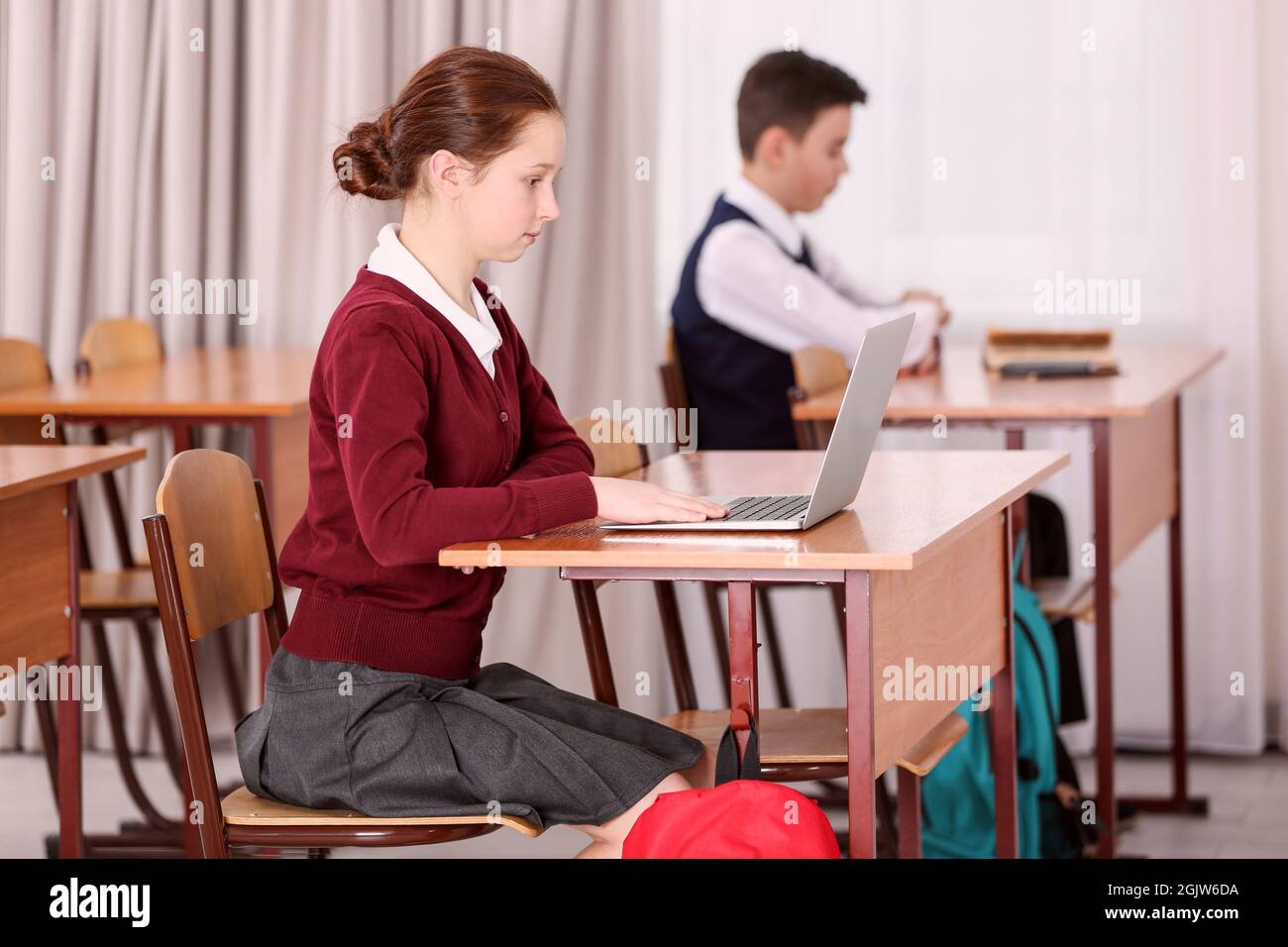Incorrect posture concept. Pupils sitting at desk in classroom Stock Photo Alamy