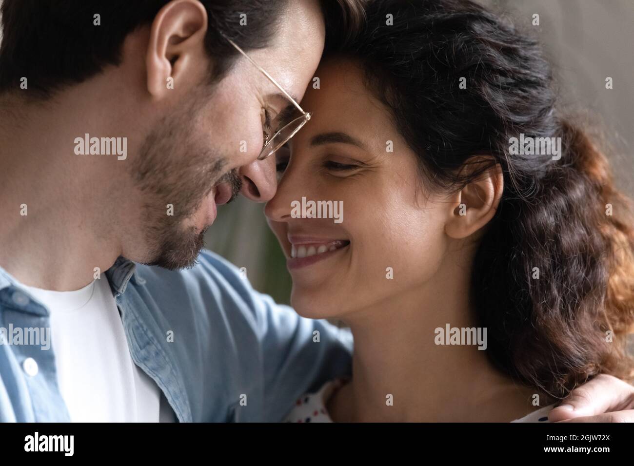 Close up smiling faces of loving young 30s couple Stock Photo