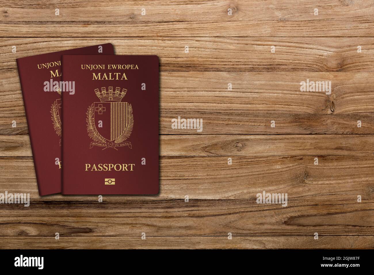 Malta passport, carried by a Maltese citizen, two passports on a wooden
