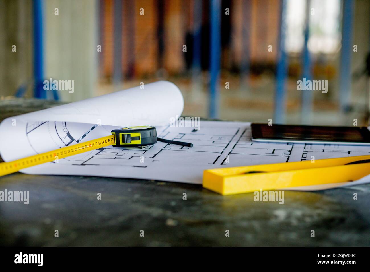 Blueprints project building, construction level and helmet, close up ...