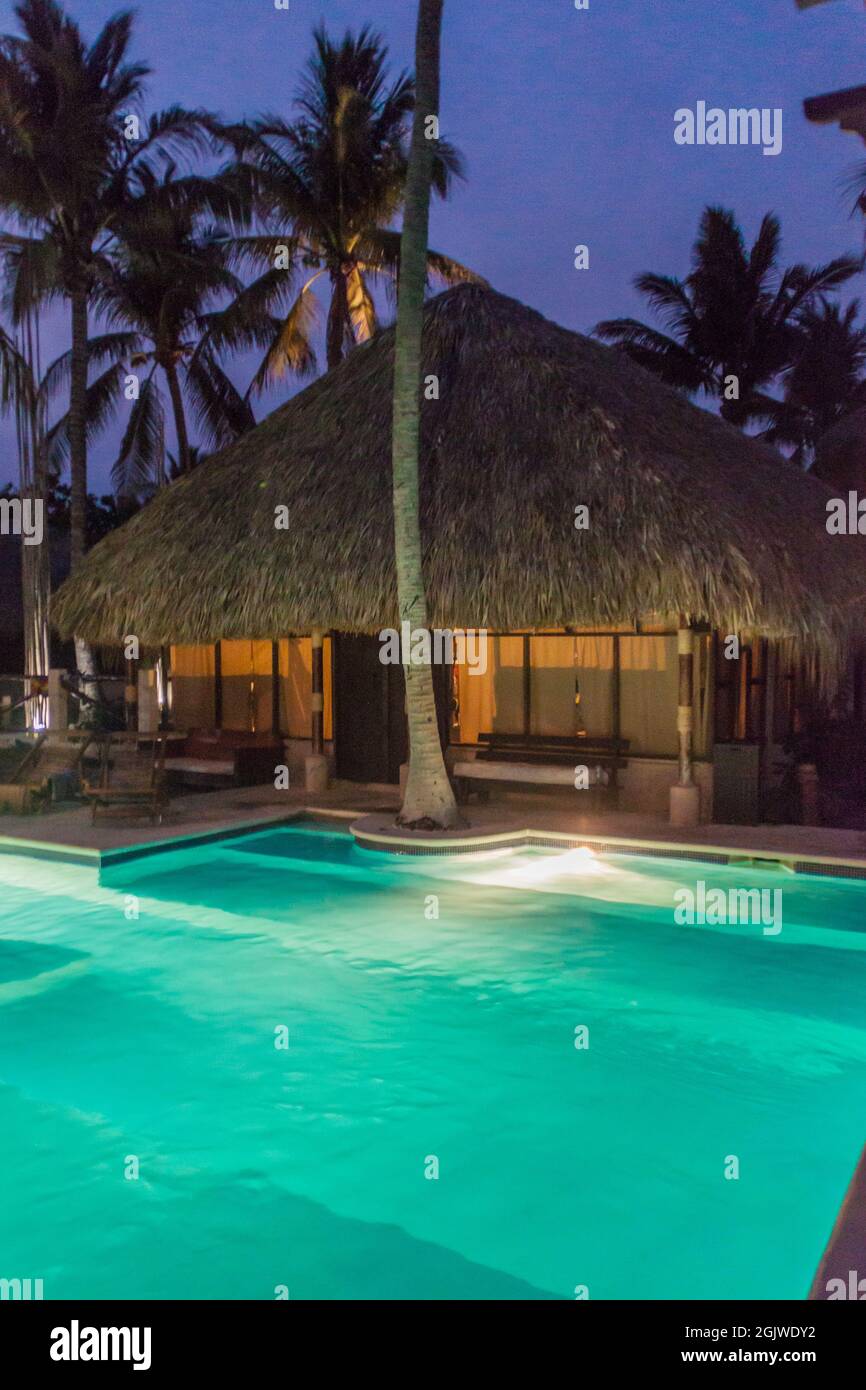 MONTERRICO, GUATEMALA - MARCH 29, 2016 Thatched hut and a pool in Johnny's Place hotel in Monterrico village. Stock Photo
