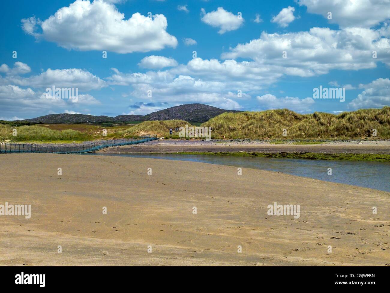Barley Cove lagoon with floating bridge and raising hills behind.County