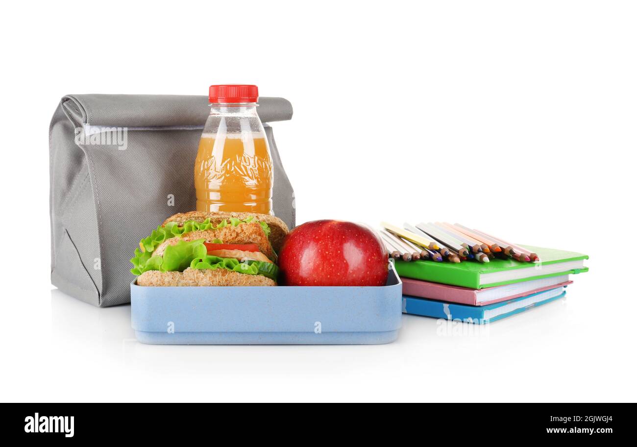Lunch box and bag with food and stationery on white background Stock