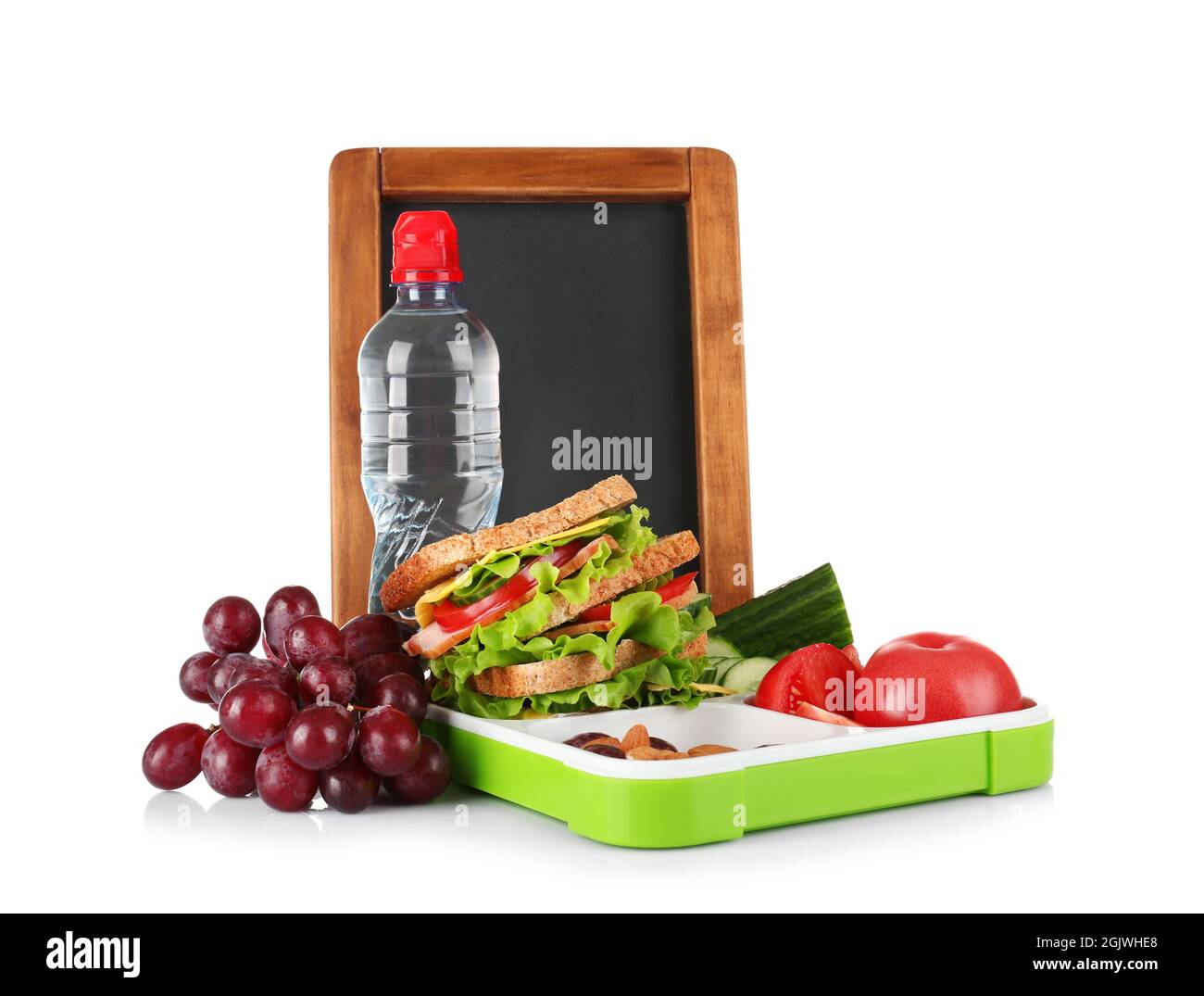Lunch box with food and bottle of water on white background Stock Photo