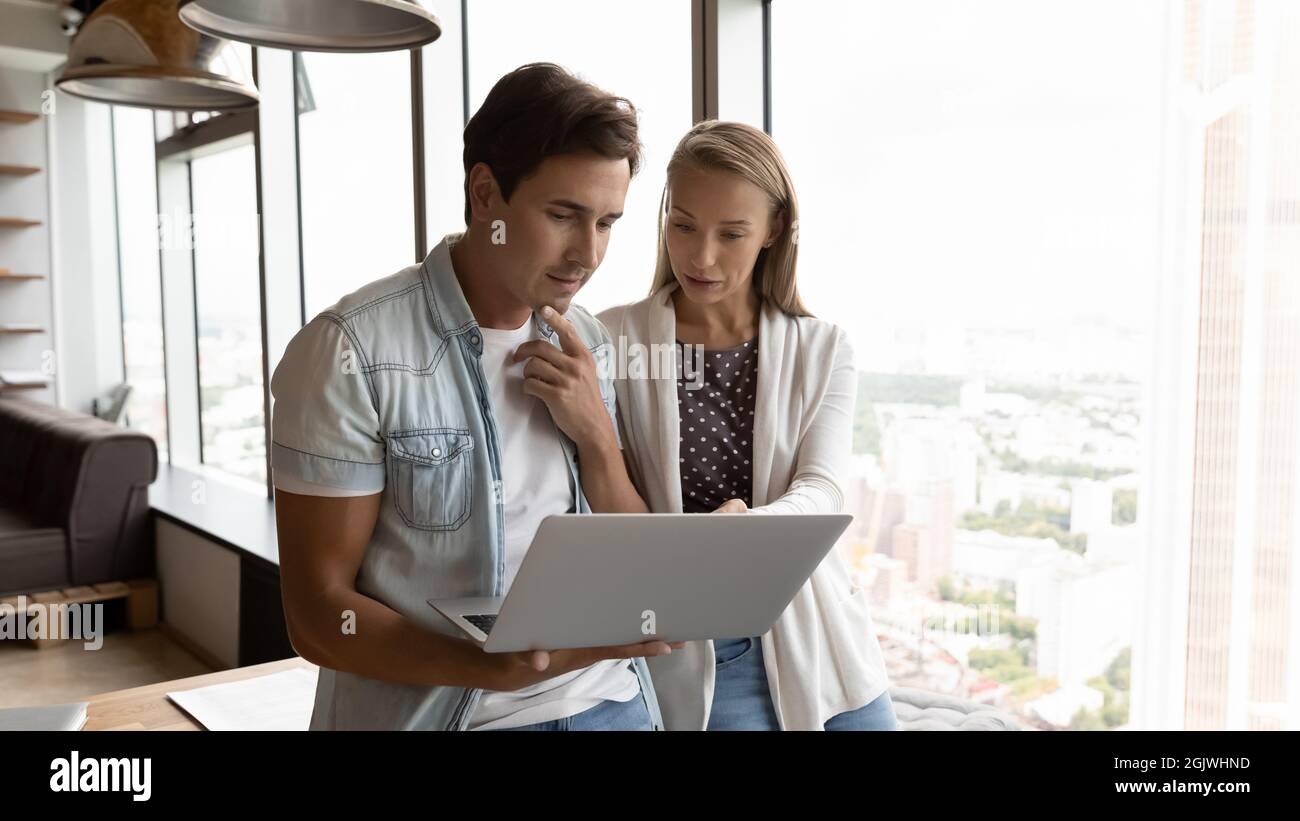 Diverse employees use computer discuss financial project online Stock Photo