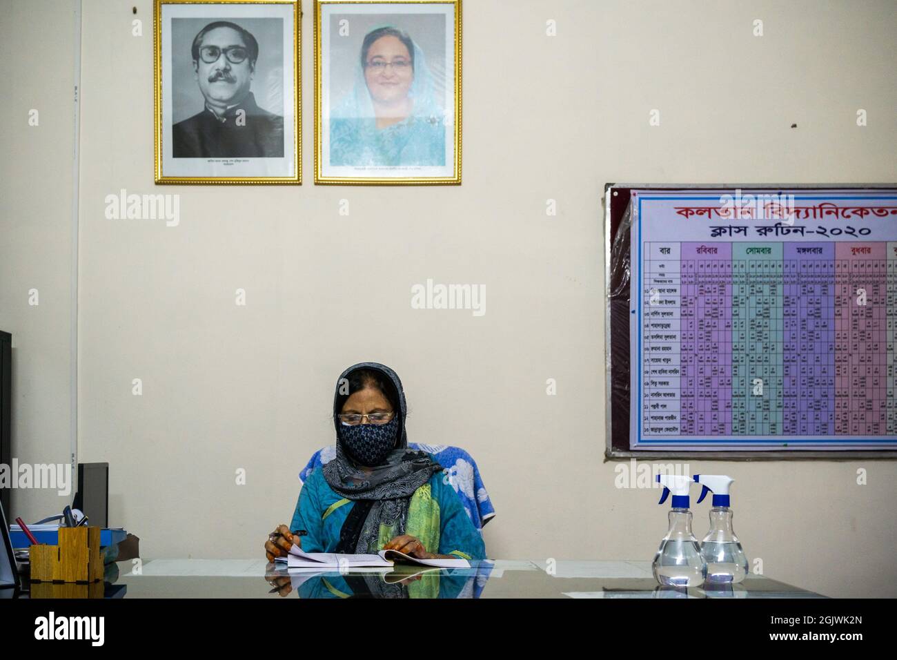 Non Exclusive: DHAKA, BANGLADESH - SEPTEMBER 11: The principal of Kolotan Bidyaniketon is seen working on the evening in his office room during the re Stock Photo