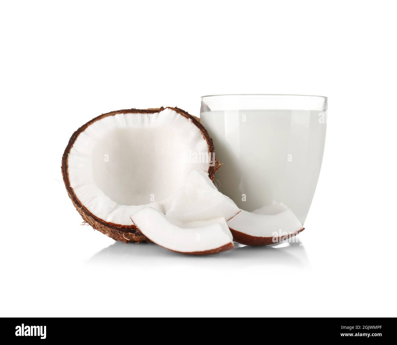 Glass of coconut milk with nut on white background Stock Photo - Alamy