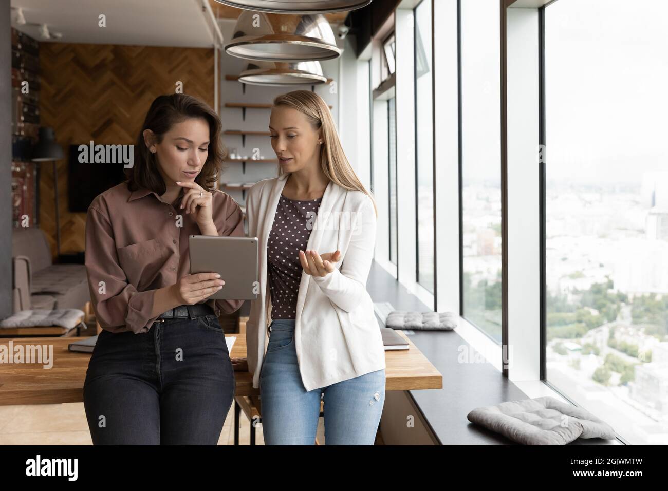 Female employees use tablet discuss online project Stock Photo