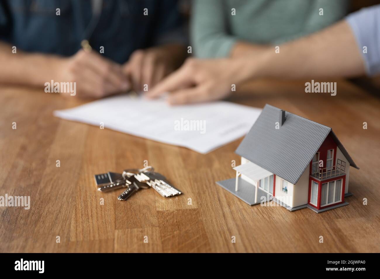 Close up of keys and house model on table Stock Photo
