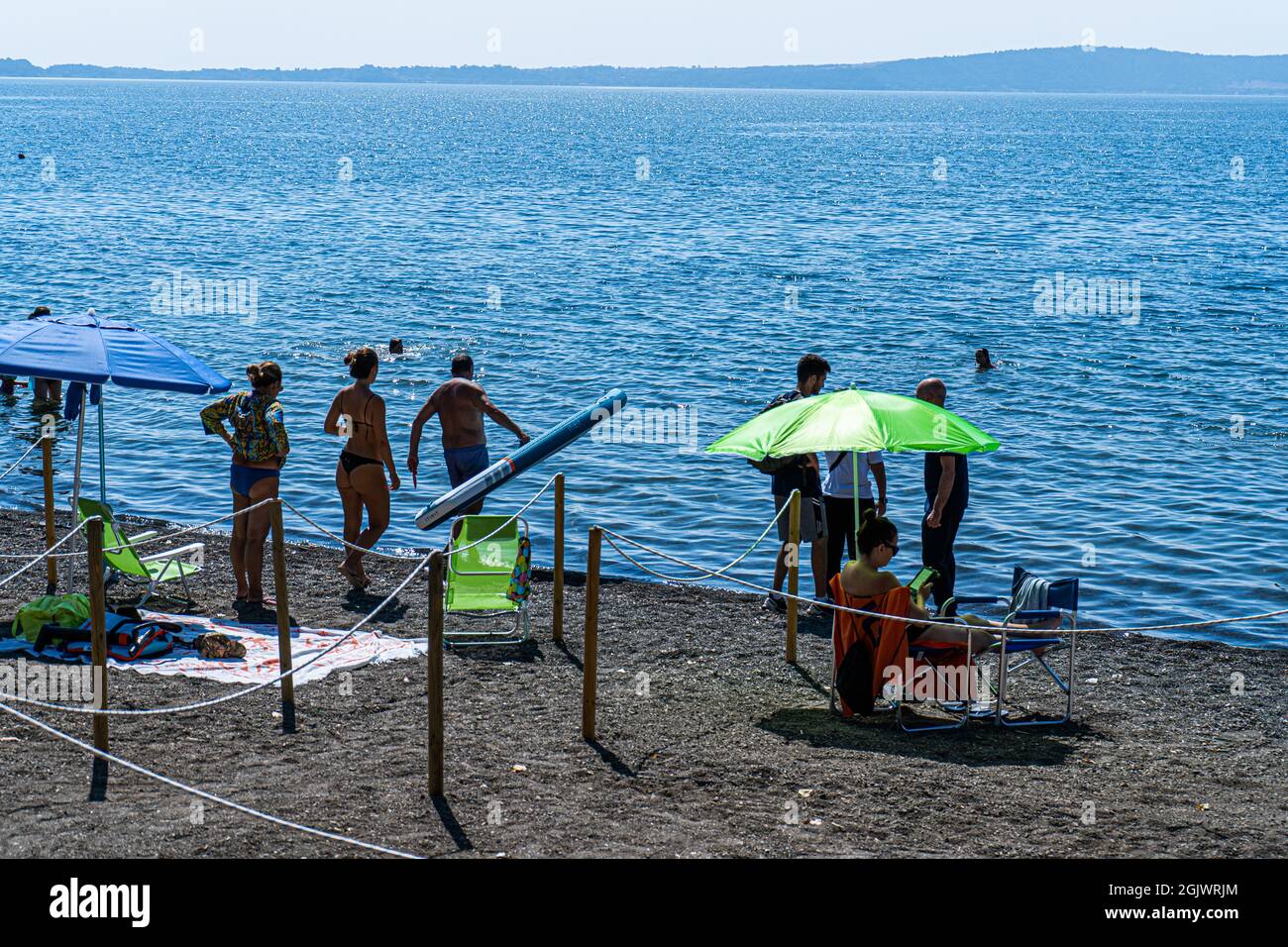 TREVIGNANO ROMANO ITALY, UK. 12 September, 2021.  The beach is crowded with sunseekers on a hot day on lake Bracciano as families and people come up for the weekend from Rome to the tourist resort of Trevignano Romano to enjoy the sunshine as temperatures remain high in September. Credit: amer ghazzal/Alamy Live News Stock Photo
