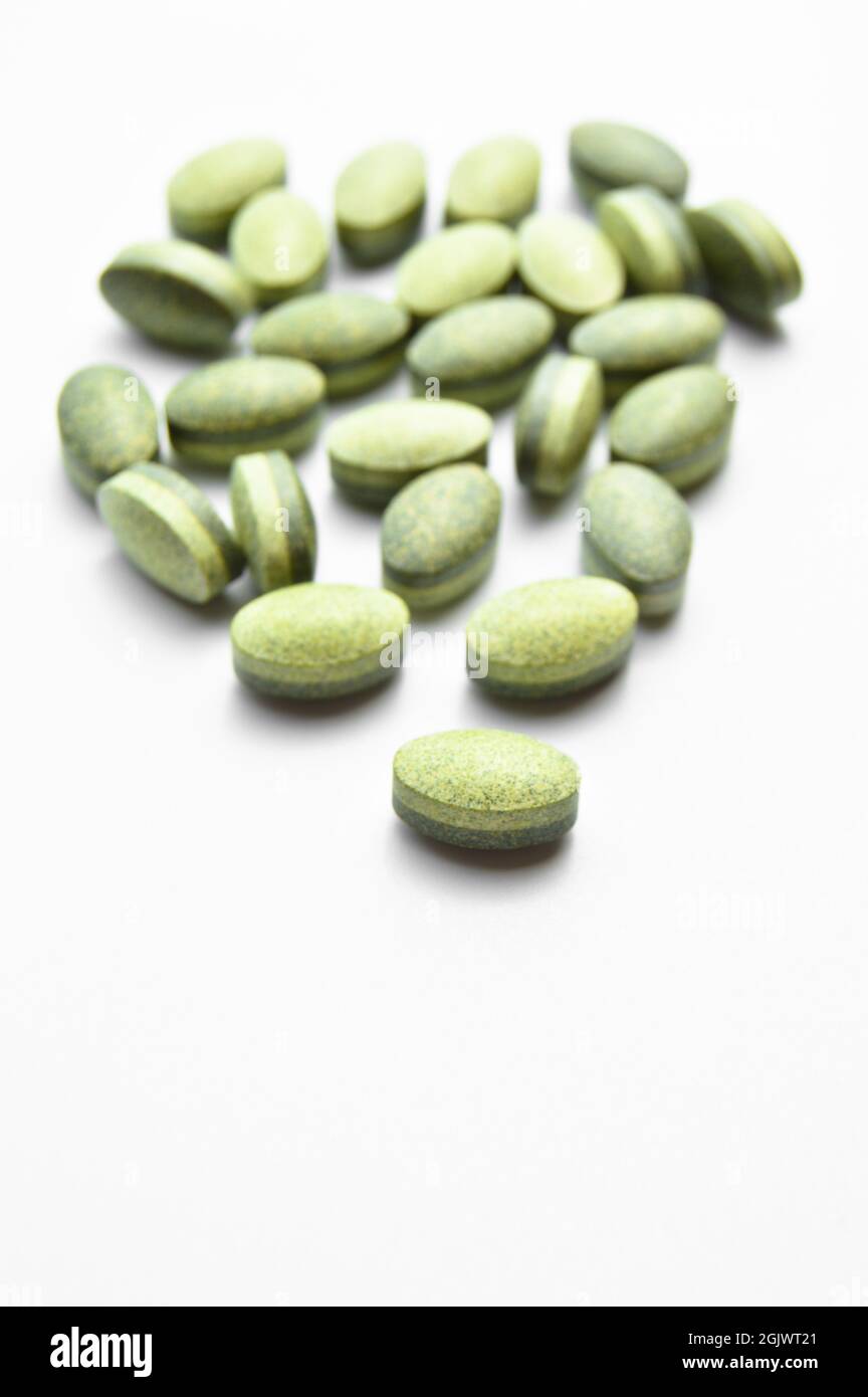 Green oval tablet pills isolated on white background, medical oval pills  tablets Stock Photo - Alamy