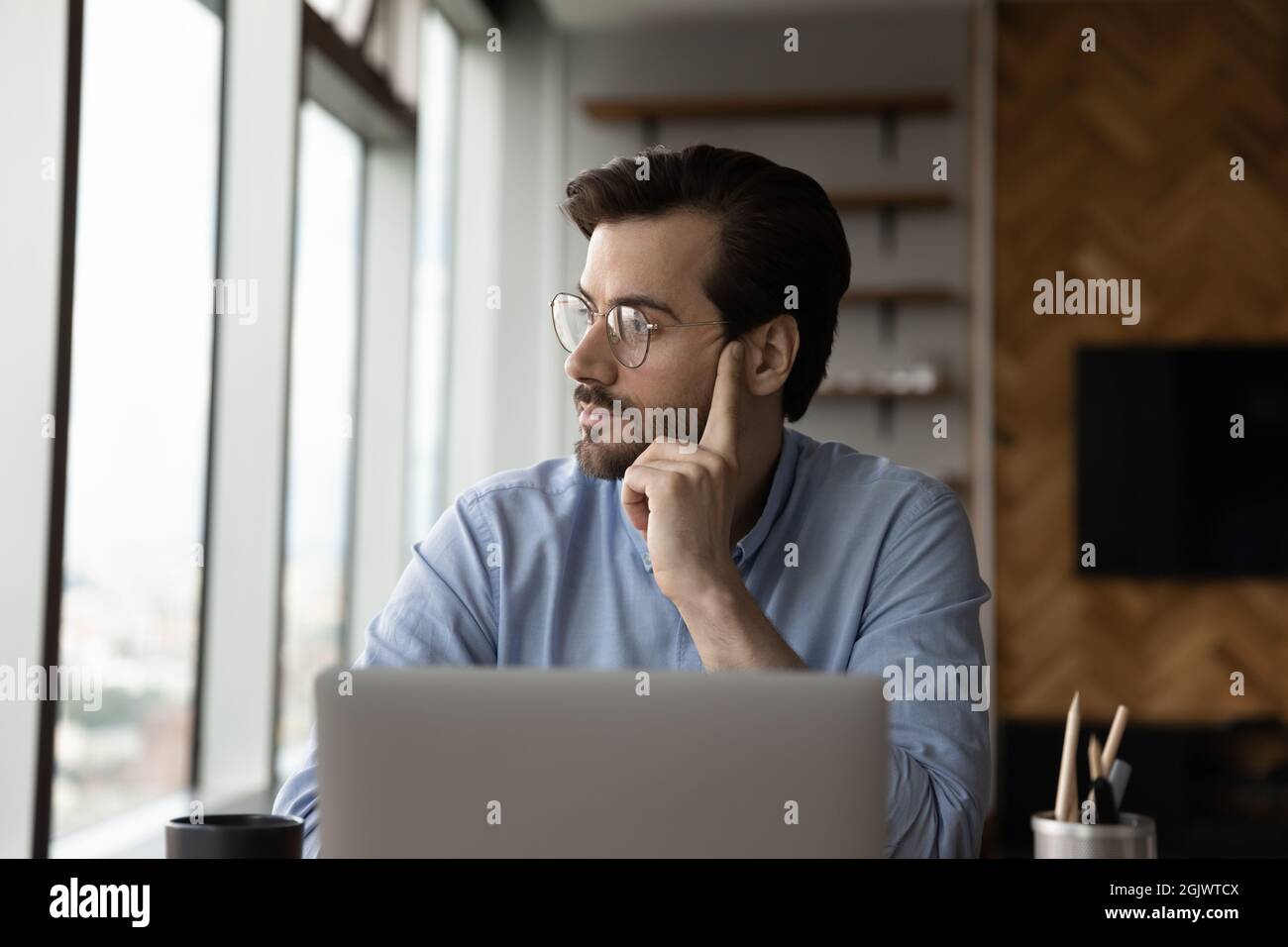 Pensive male employee feel bored working on computer Stock Photo - Alamy
