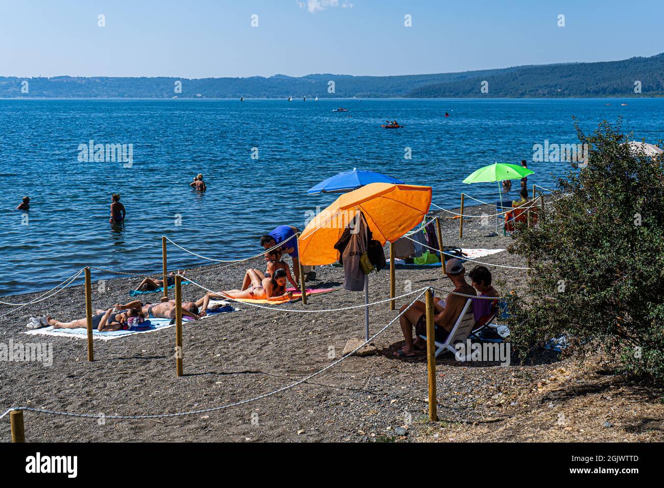 TREVIGNANO ROMANO ITALY, UK. 12 September, 2021.  The beach is crowded with sunseekers on a hot day on lake Bracciano as families and people come up for the weekend from Rome to the tourist resort of Trevignano Romano to enjoy the sunshine as temperatures remain high in September. Credit: amer ghazzal/Alamy Live News Stock Photo