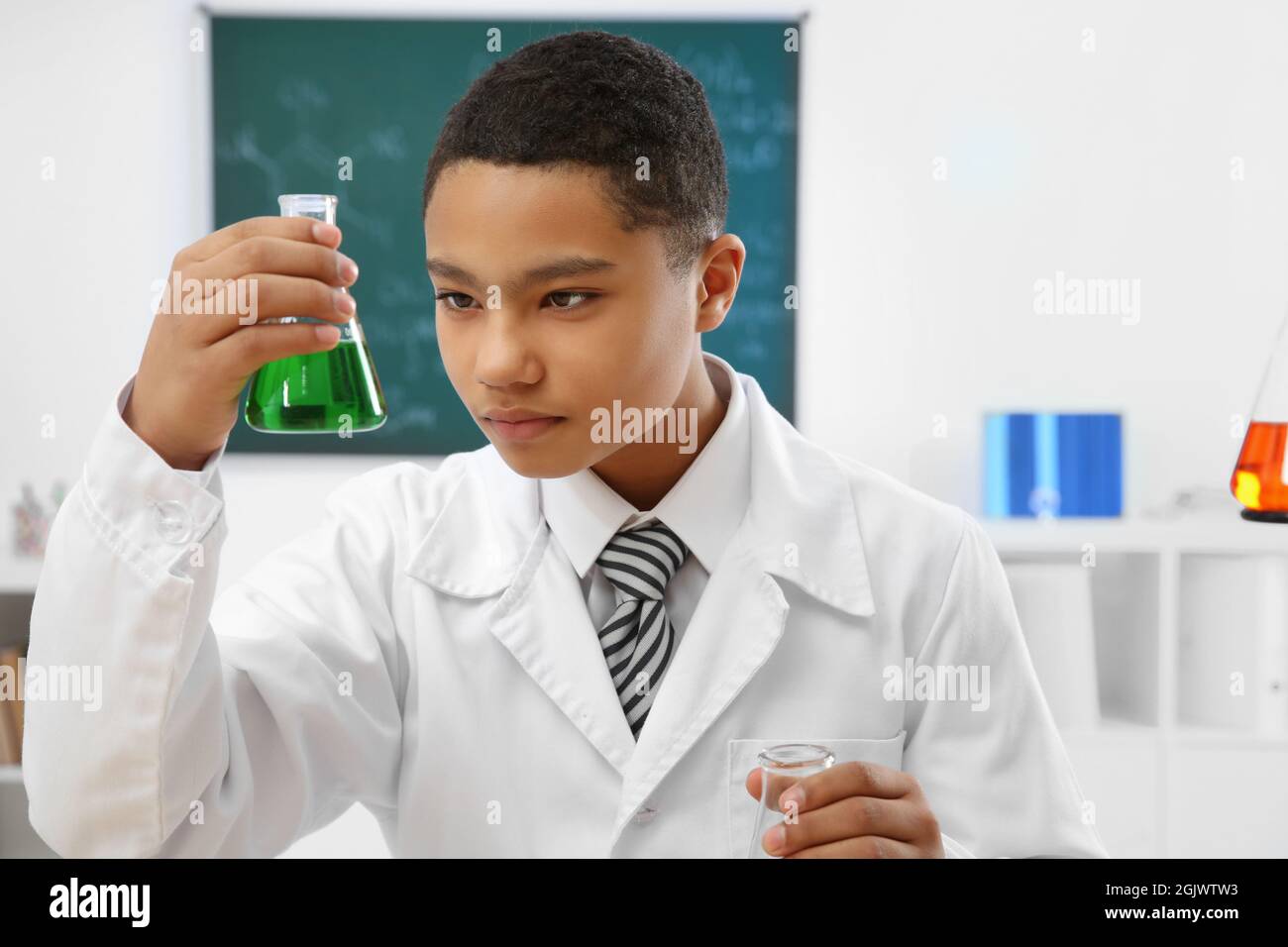 School boy making experiment in chemistry class Stock Photo - Alamy