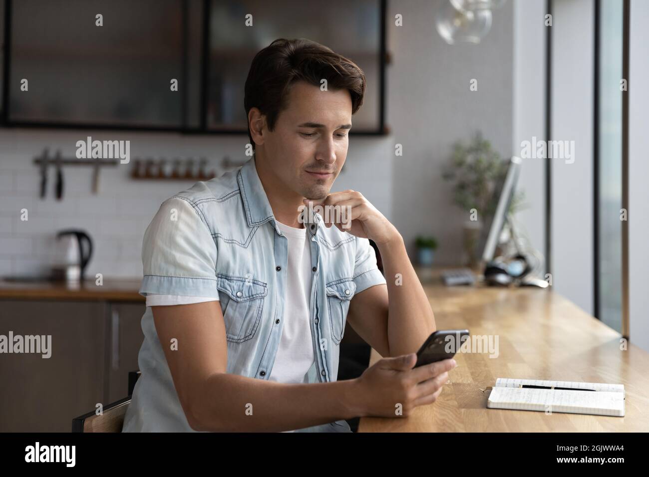 Young Caucasian man use cellphone browsing internet Stock Photo